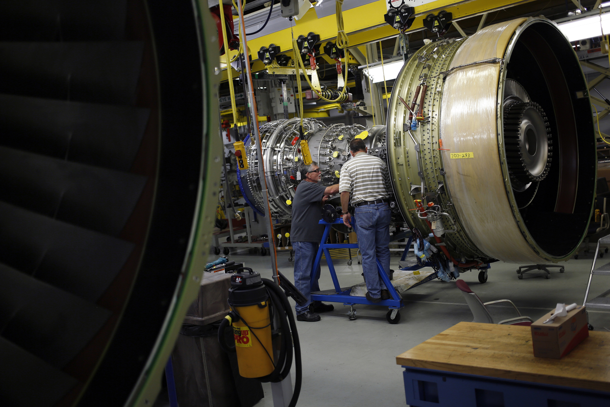 Workers assemble a General Electric Co. CF6-80C2 jet engine at the GE Aviation factory in Cincinnati, Ohio, June 25, 2014.