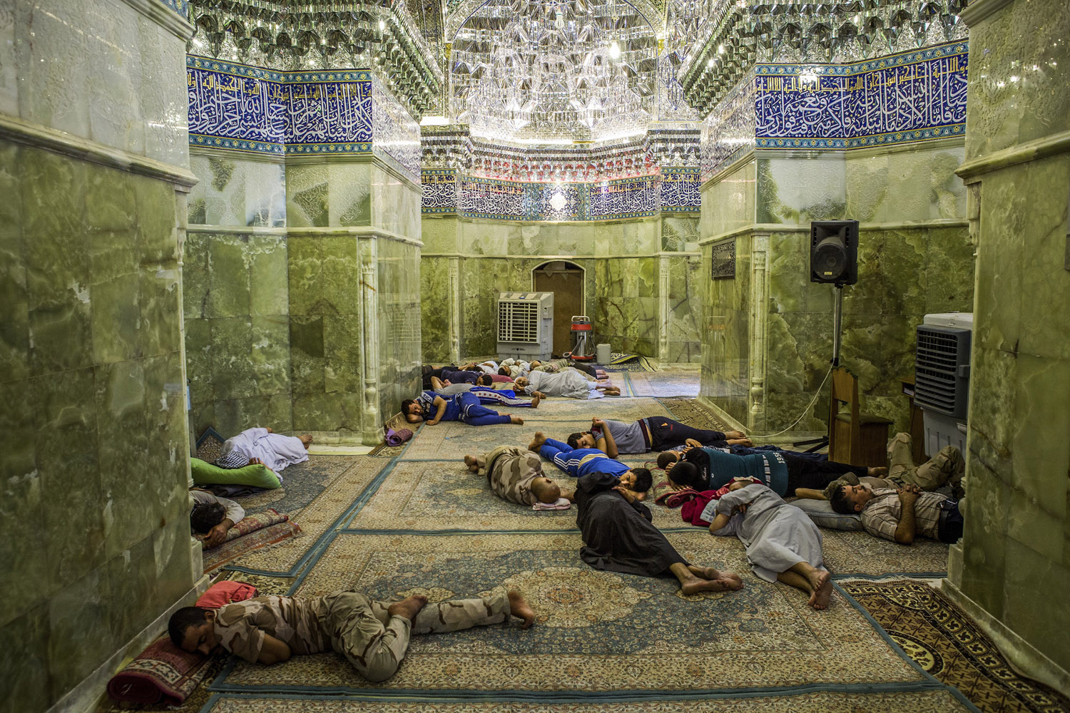Shiite volunteers sleep during the mid-day heat inside the Askariya Shrine, where two imams revered by Shiites are buried, in Samarra, Iraq.