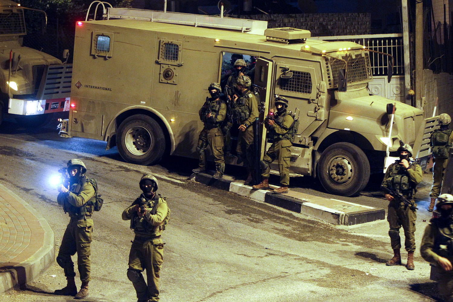 Israeli military patrols the streets in the West Bank city of Hebron on July 6, 2014 (Abed Al Hashlamoun—EPA)