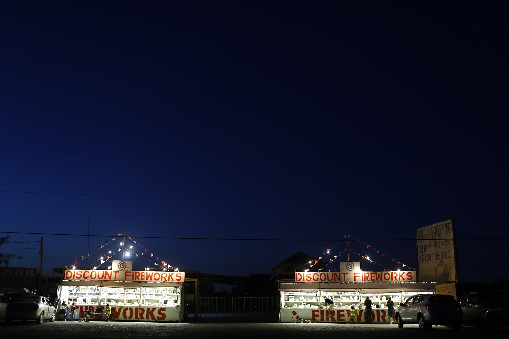 The Medrano's fireworks stand, left, and Cynthia Fuentes and Nelson Zamora's, right, Hidalgo, Texas, July 1, 2014.