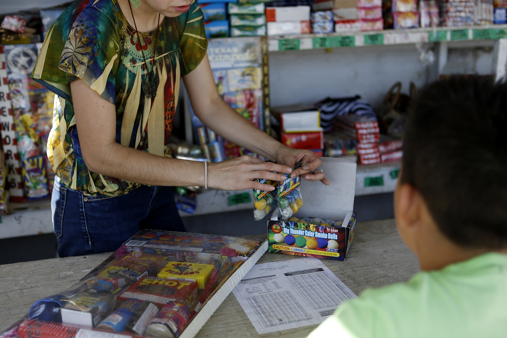 Ilene sells fireworks to a customer in Hidalgo, Texas on July 1, 2014.