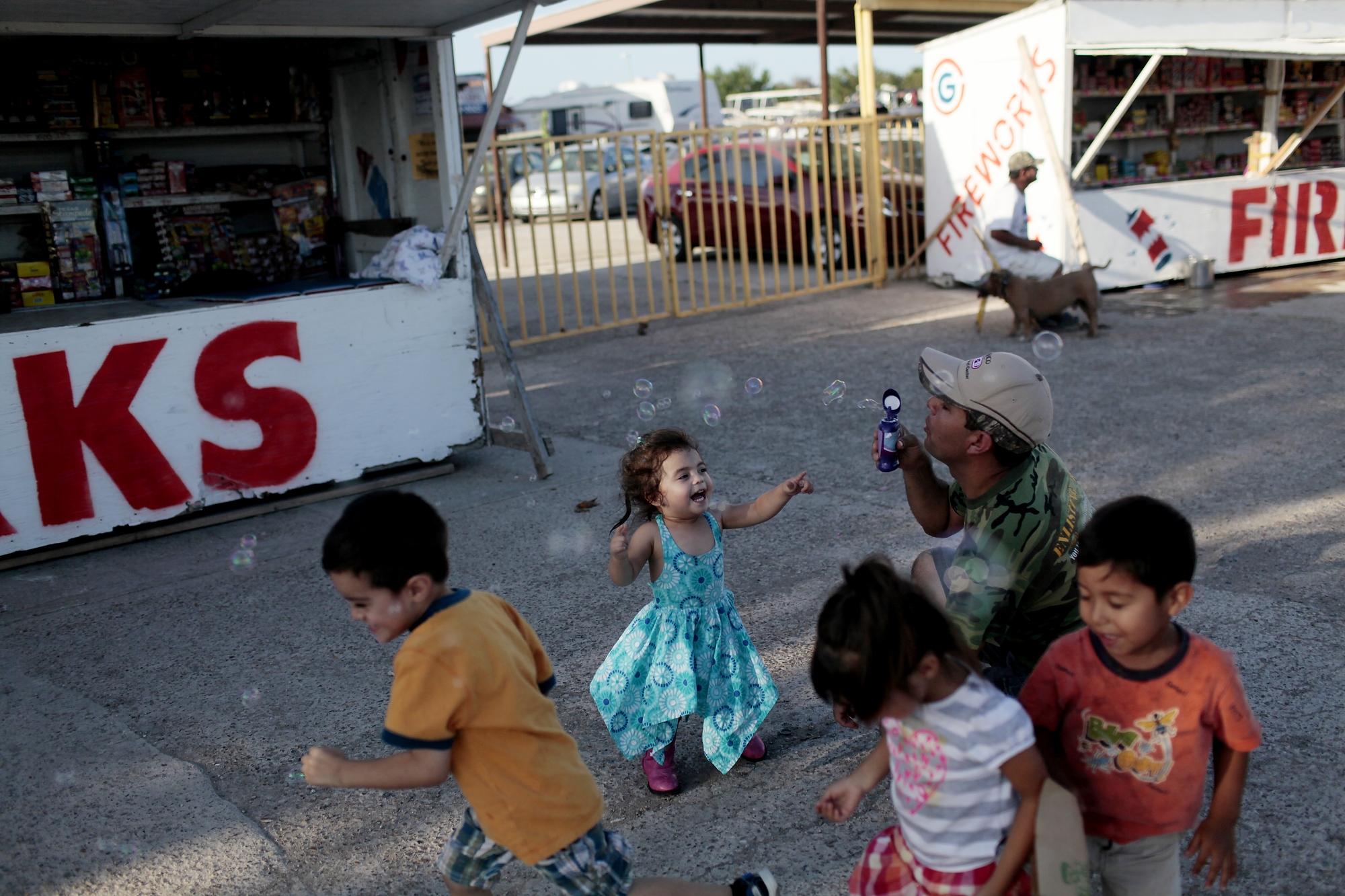 Gregorio plays with his daugther, Sarah, son, Sean, and other children at his fireworks stand in Hidalgo, Texas on July 1, 2014.