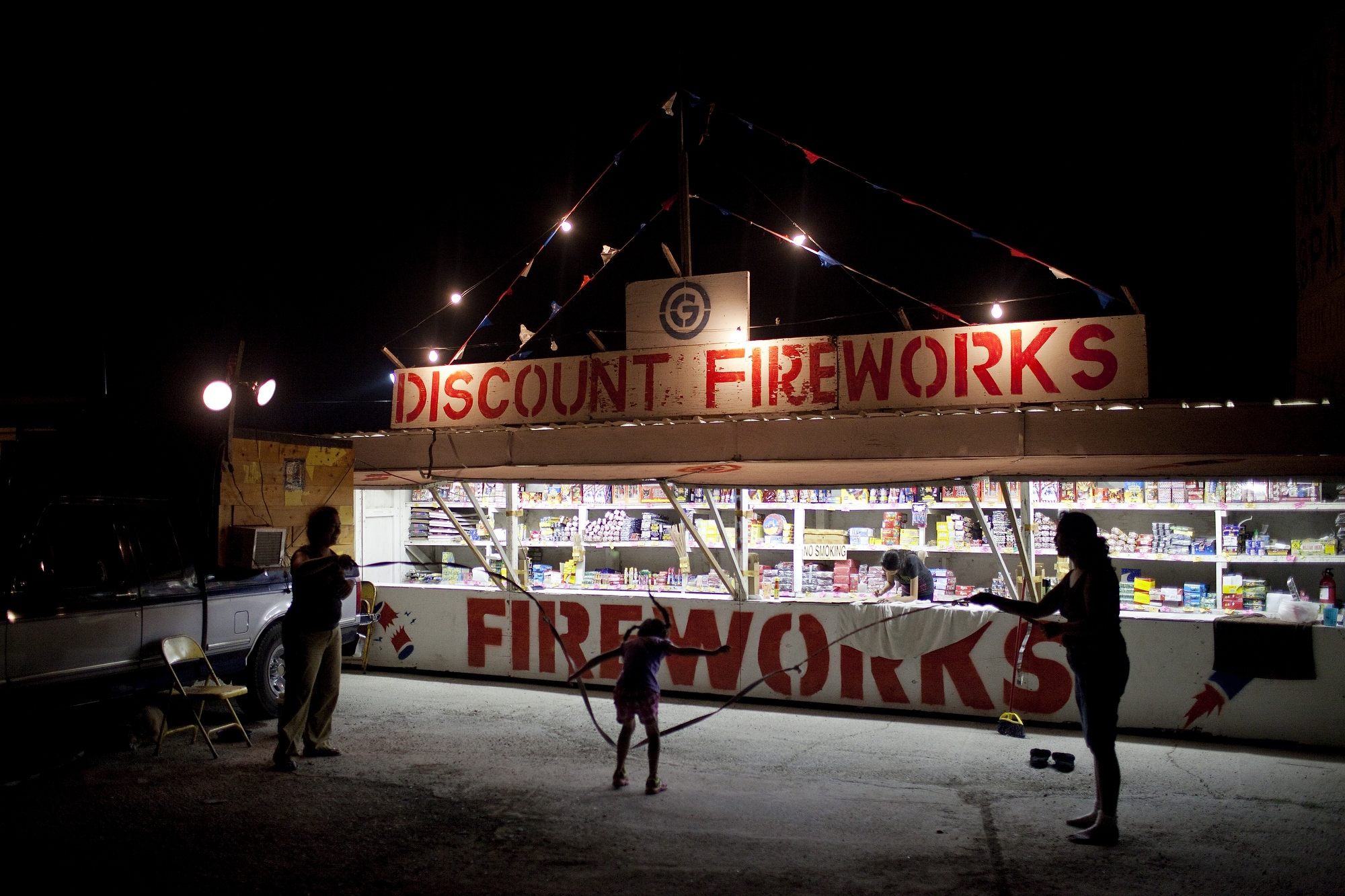 Families pass time jumping rope at their fireworks stand in Hidalgo, Texas on July 1, 2014.