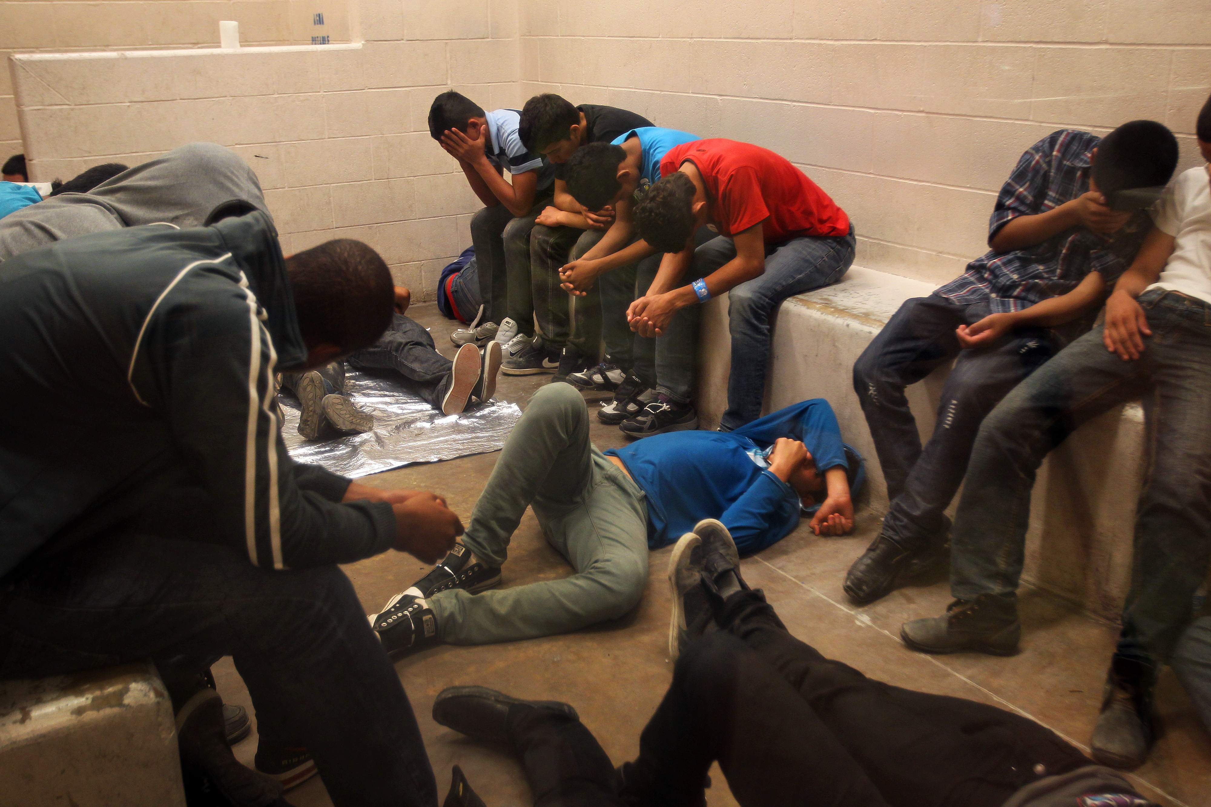 Immigrants who have been caught crossing the border illegally are housed inside the McAllen Border Patrol Station in McAllen, Texas where they are processed on July 15, 2014 in McAllen, Texas. (Pool—Getty Images)