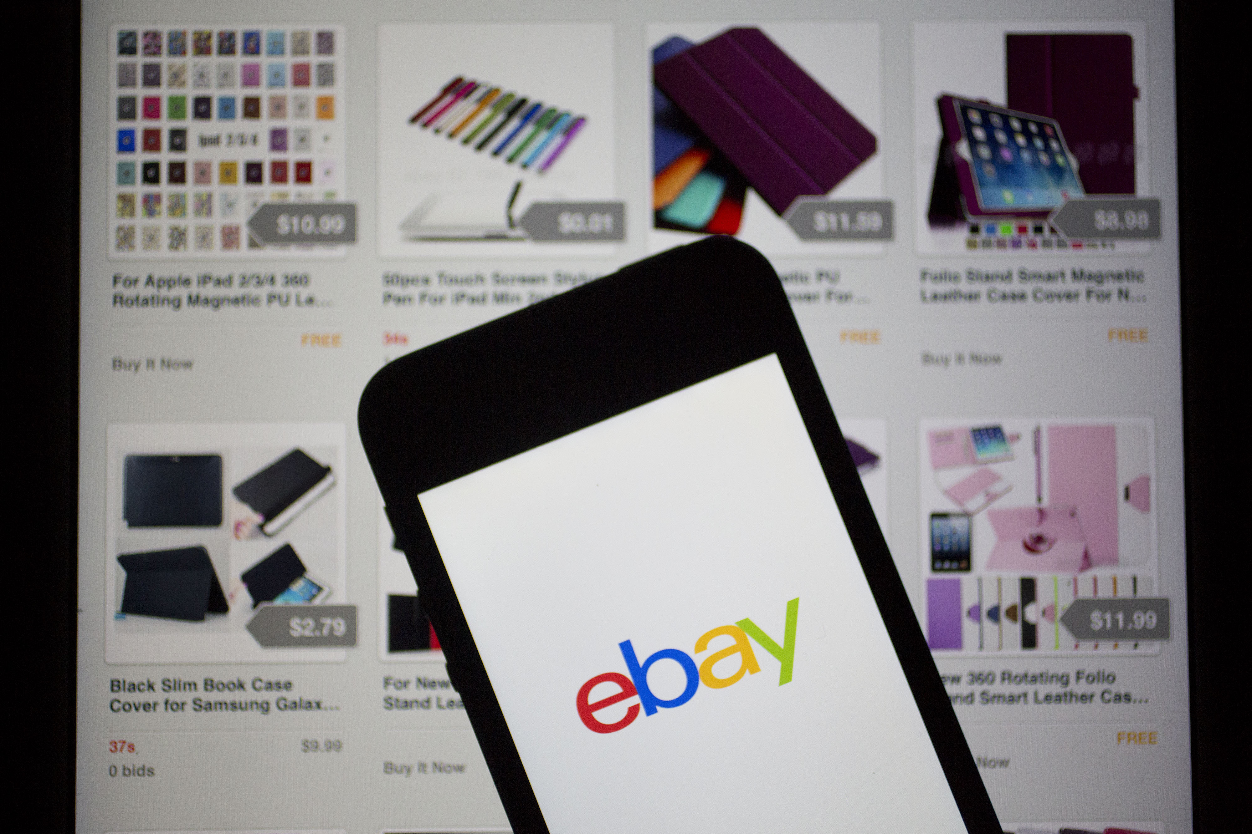 The eBay Inc. logo and application are displayed on a an Apple Inc. iPhone 5 and iPad in this arranged photograph in Washington on April 25, 2014. (Andrew Harrer—Bloomberg/Getty Images)