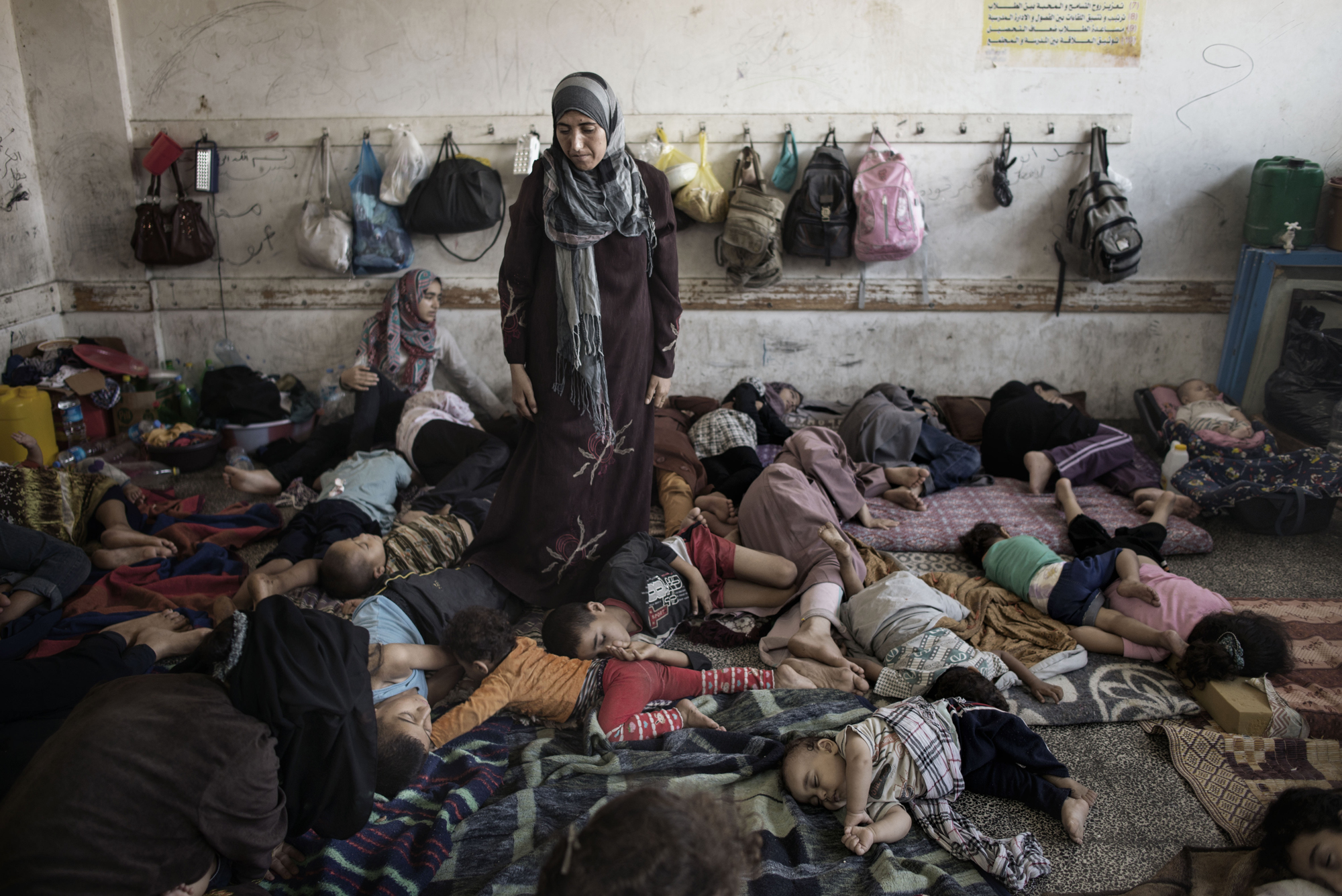 Displaced Palestinians from Beit Hanoun sleep inside the UNRWA school in Jabalia, July 23, 2014.