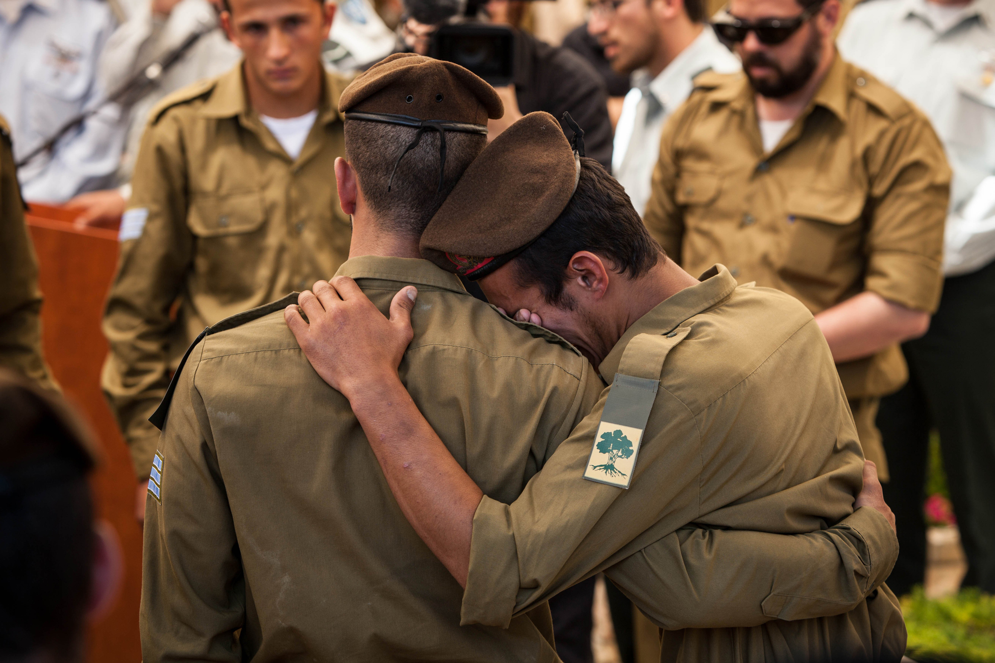 Comrades of slain Sgt. Max Steinberg are comforting each other at Mt. Herzl cemetery, Jerusalem, July 23,2014.