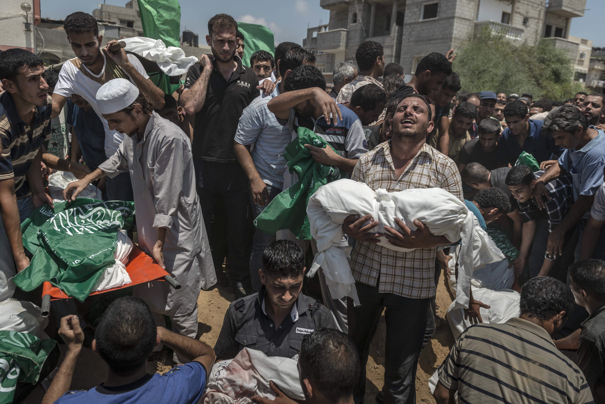 Palestinian men bury the bodies of a family who was killed after airstrike in Khan Younis, in the Gaza Strip.