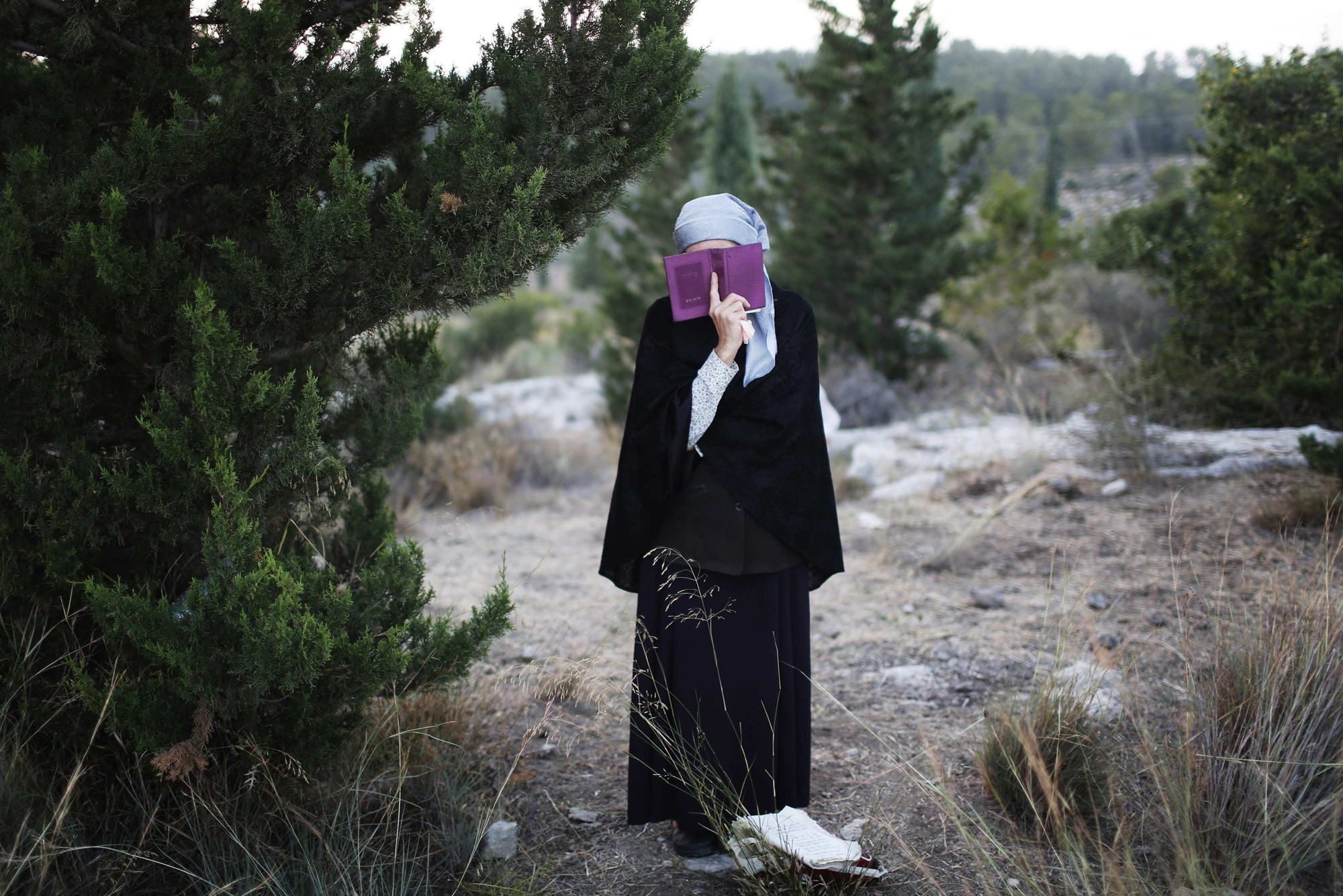 A Jewish woman prays during the joint funeral of the three Israeli teens who were abducted and killed in the occupied West Bank, in the Israeli city of Modi'in July 1.