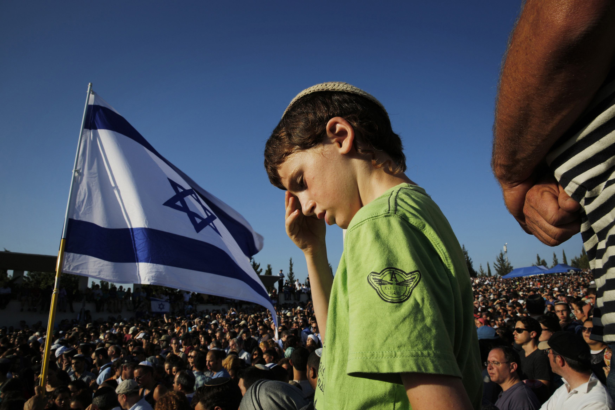 An Israeli boy attends the joint funeral of three Israeli teens, Gil-Ad Shaer, U.S.-Israeli national Naftali Fraenkel, both 16, and Eyal Yifrah, 19, who were abducted and killed in the occupied West Bank, in the Israeli city of Modi'in July 1.