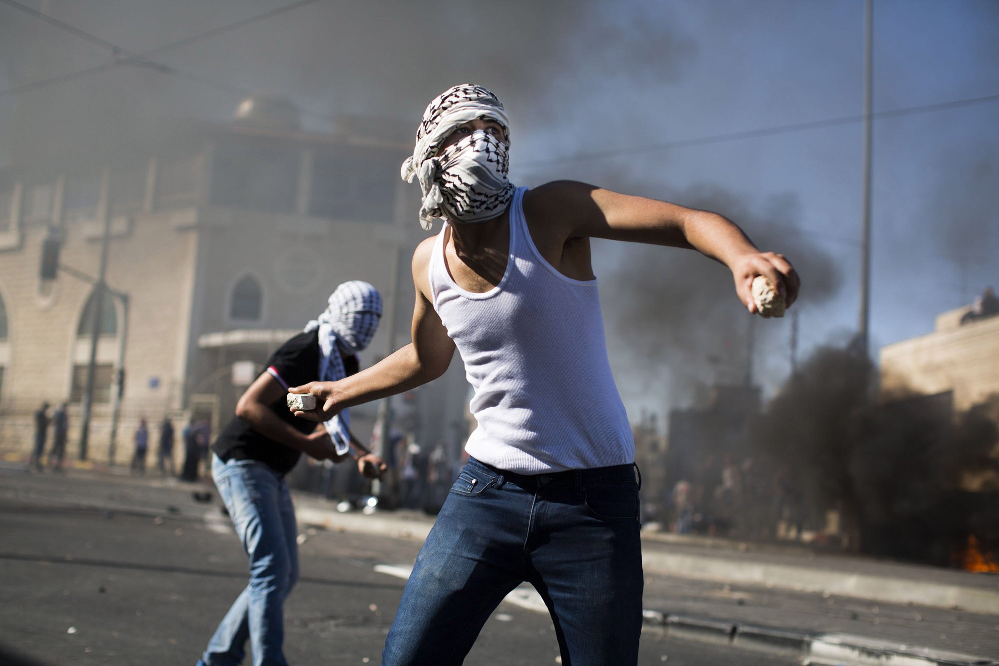 Palestinian youths clash with Israeli police in Jerusalem on July 2.