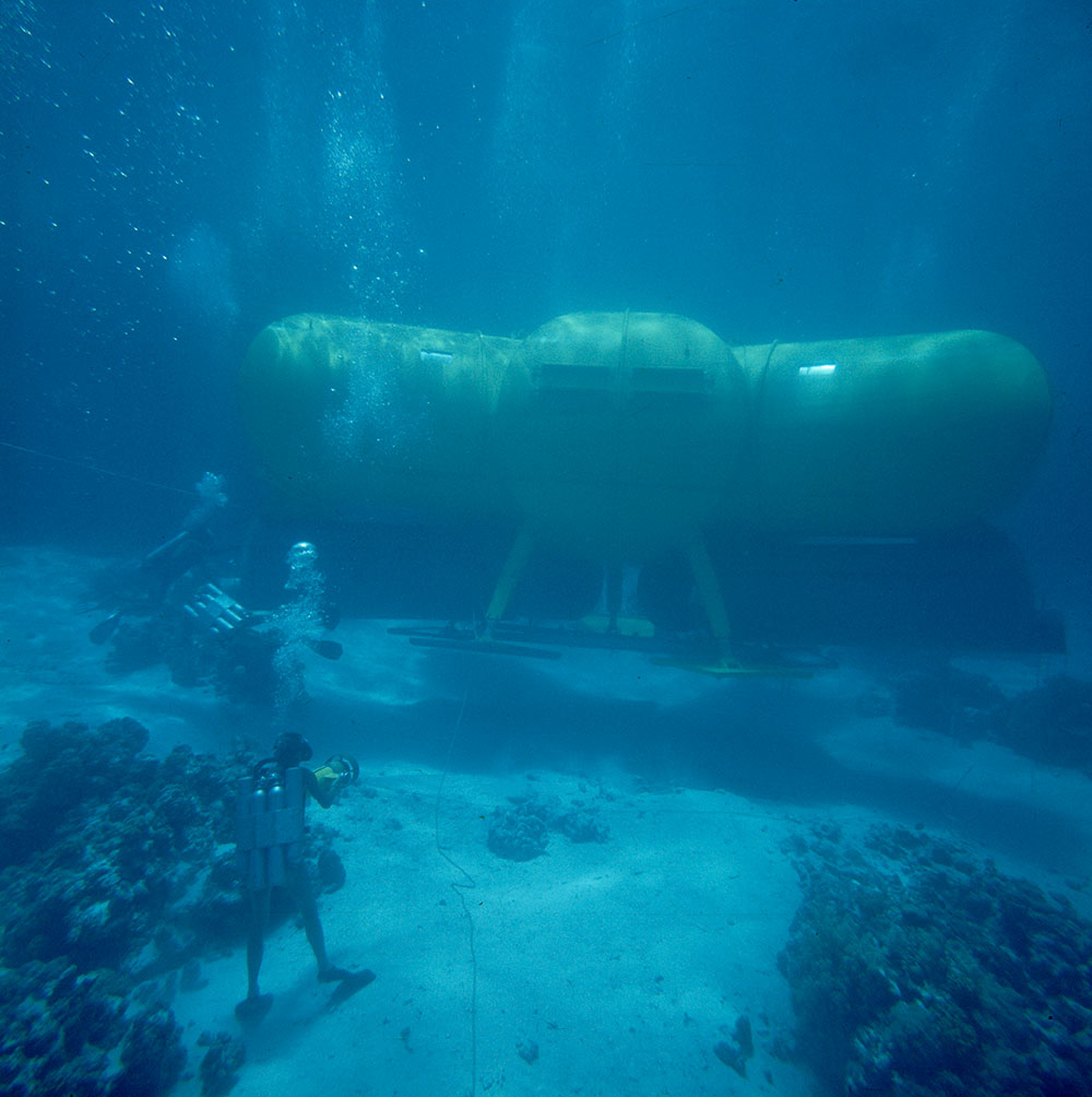 A diver films the Conshelf II submersible on the floor of the Red Sea in 1963.