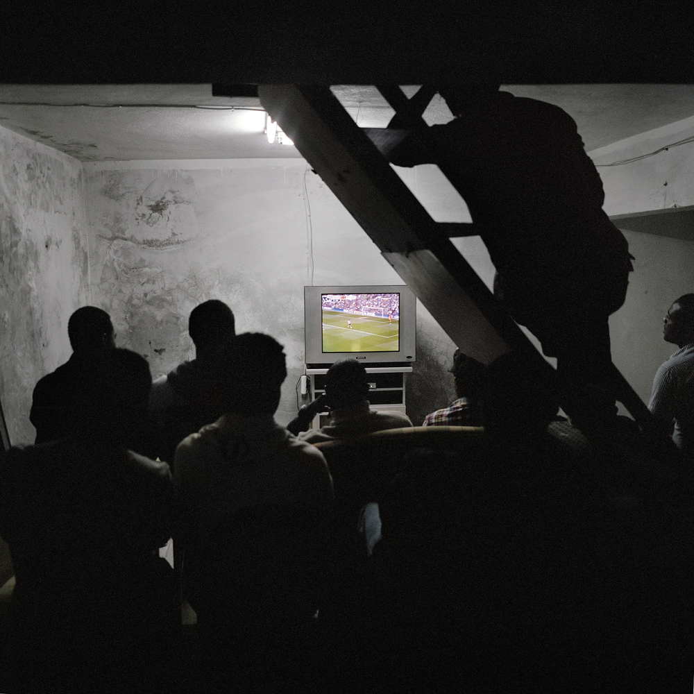 A group of African men crowd the basement of an internet cafe to watch the Chelsea vs. Tottenham football match after paying the shop keeper .50 cents on April 30, 2011 in the Kurtulus neighborhood of Istanbul, Turkey.