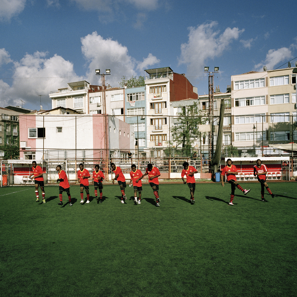 Nigerian footballers playing for Tanzania stretch their legs out before their Africa Community Cup match against Ivory Coast on the run-down Feriköy pitch in Kurtulus on July 29, 2012 in Istanbul, Turkey.