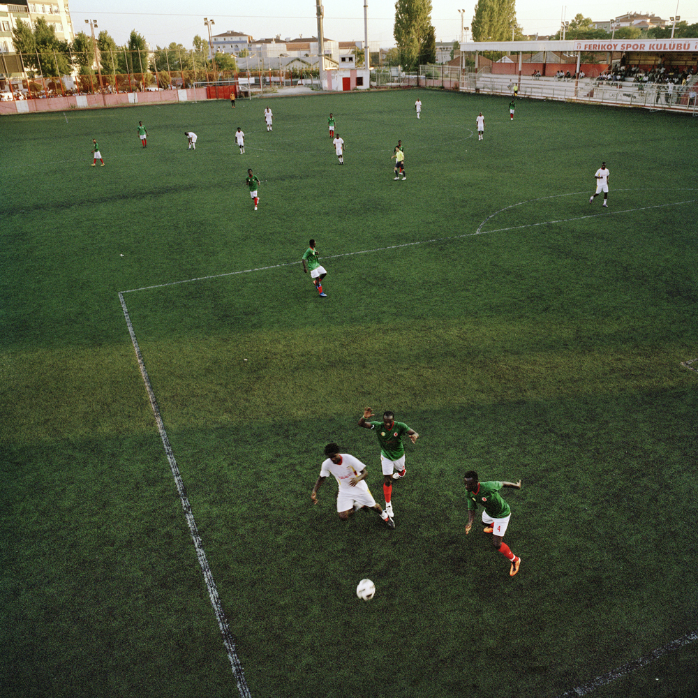 Guinea and Uganda play against each other in the semi-final match of the Africa Community Cup that's held every year on the run-down Feriköy pitch in the Kurtulus neighborhood on August 4, 2012 in Istanbul, Turkey.