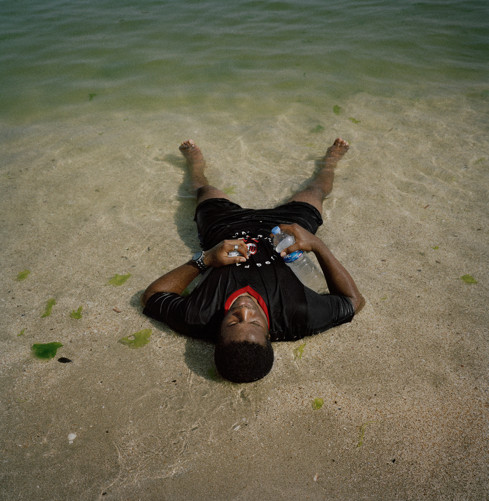 Jerry, a Nigerian footballer, lays in the sea at a beach near his home after spending the afternoon training in August 2011 in Istanbul, Turkey.