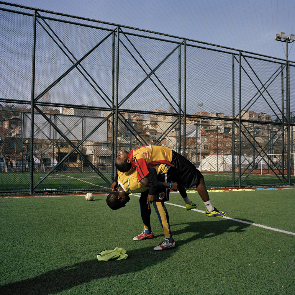 Two Nigerian footballers stretch during a morning workout for SIBM LTDA, a training program run by Sevgi Adar, a Cameroonian agent based in Turkey in January 2014 in Istanbul, Turkey.