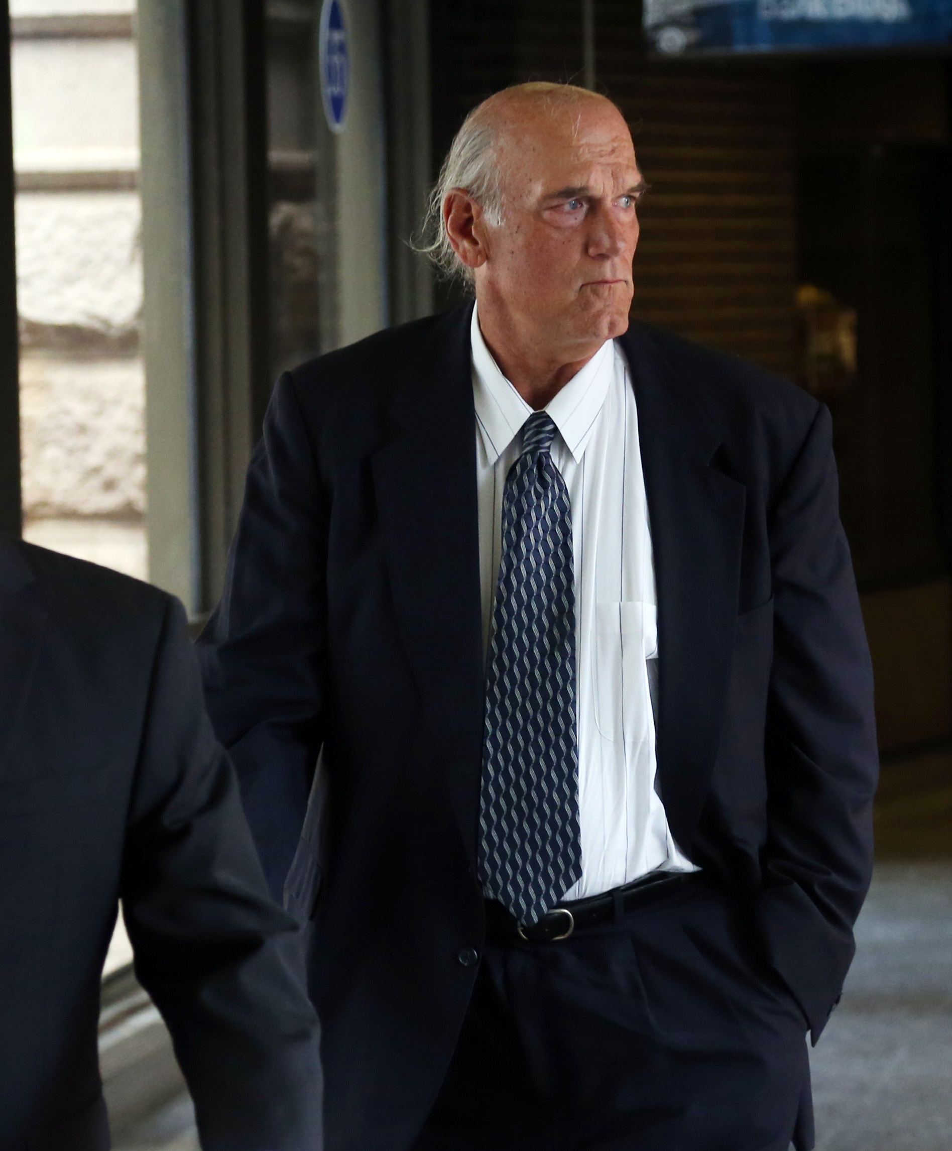 Former Minnesota Gov. Jesse Ventura makes his way back into Warren E. Burger Federal Building during the first day of jury selection in a defamation lawsuit, on July 8, 2014 in St. Paul, Minn. (Jim Mone—AP)
