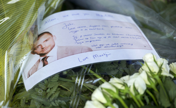A bunch of flowers with a picture and a message for John Allen, a British lawyer who died with his Dutch wife and three sons on flight MH17, is placed at Schiphol airport, in Amsterdam, July 20, 2014.