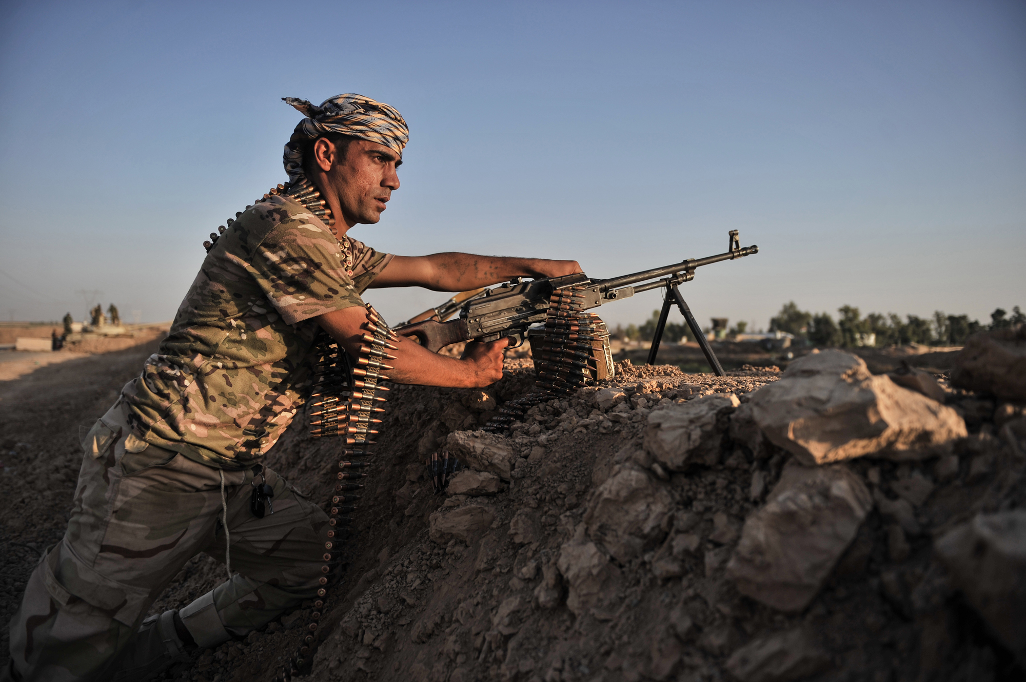 Kurdish Peshmerga forces stand guard in the oil-rich city of Kirkuk against Islamic State of Iraq and Syria (ISIS) on June 17, 2014. (Onur Coban—Anadolu Agency/Getty Images)