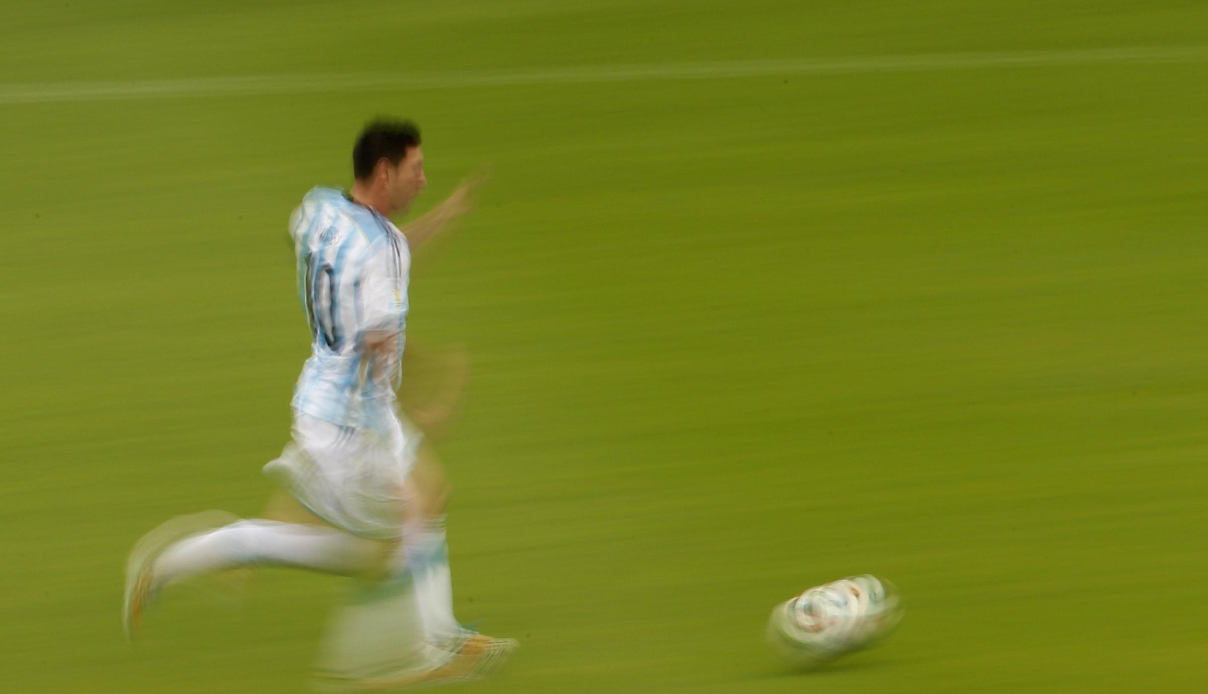Argentina's Lionel Messi runs with the ball during the Group F football match between Nigeria and Argentina at the Beira-Rio Stadium in Porto Alegre on June 25, 2014,