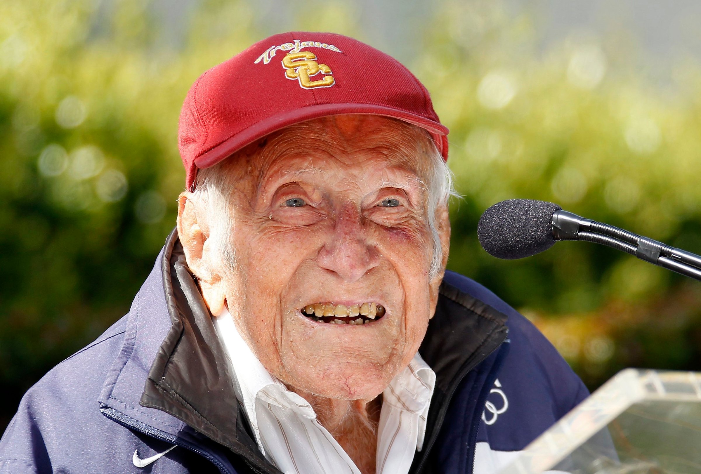 Louis Zamperini gestures during a news conference, in Pasadena, Calif. Zamperini, a U.S. Olympic distance runner and World War II veteran who survived 47 days on a raft in the Pacific after his bomber crashed, then endured two years in Japanese prison camps, died Wednesday, July 2, 2014.