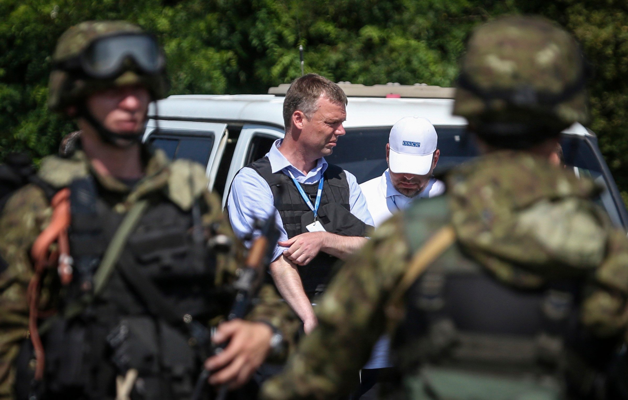 Alexander Hug deputy head for the Organisation for Security and Cooperation in Europe's (OSCE) monitoring mission in Ukraine, looks on next to armed pro-Russian separatists on the way to the Malaysia Airlines flight MH17 crash site, near Donetsk on July 30, 2014.
