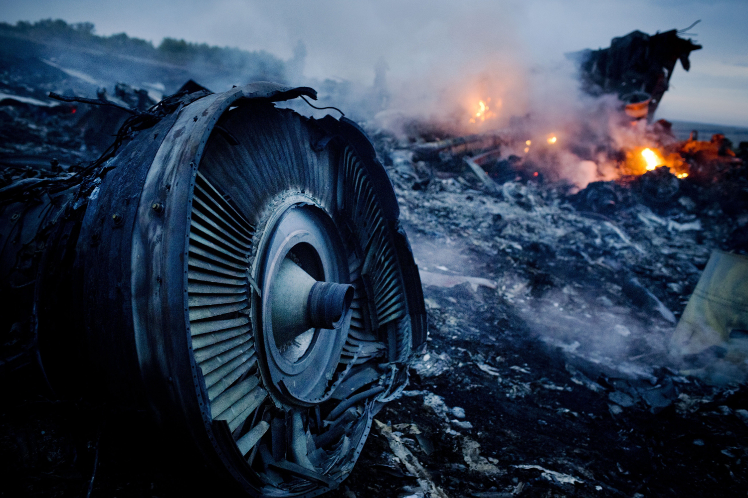 Debris from Malaysia Airlines Flight 17 is shown smouldering in a field July 17, 2014 in Grabovo, Ukraine.