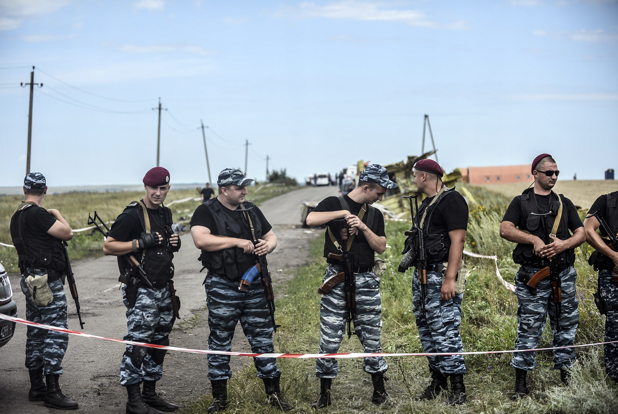 Armed pro-Russian separatists stand guard in front of the crash site of Malaysia Airlines Flight MH17, near the village of Grabove, in the region of Donetsk on July 20, 2014. (Bulent Kilic—AFP/Getty Images)