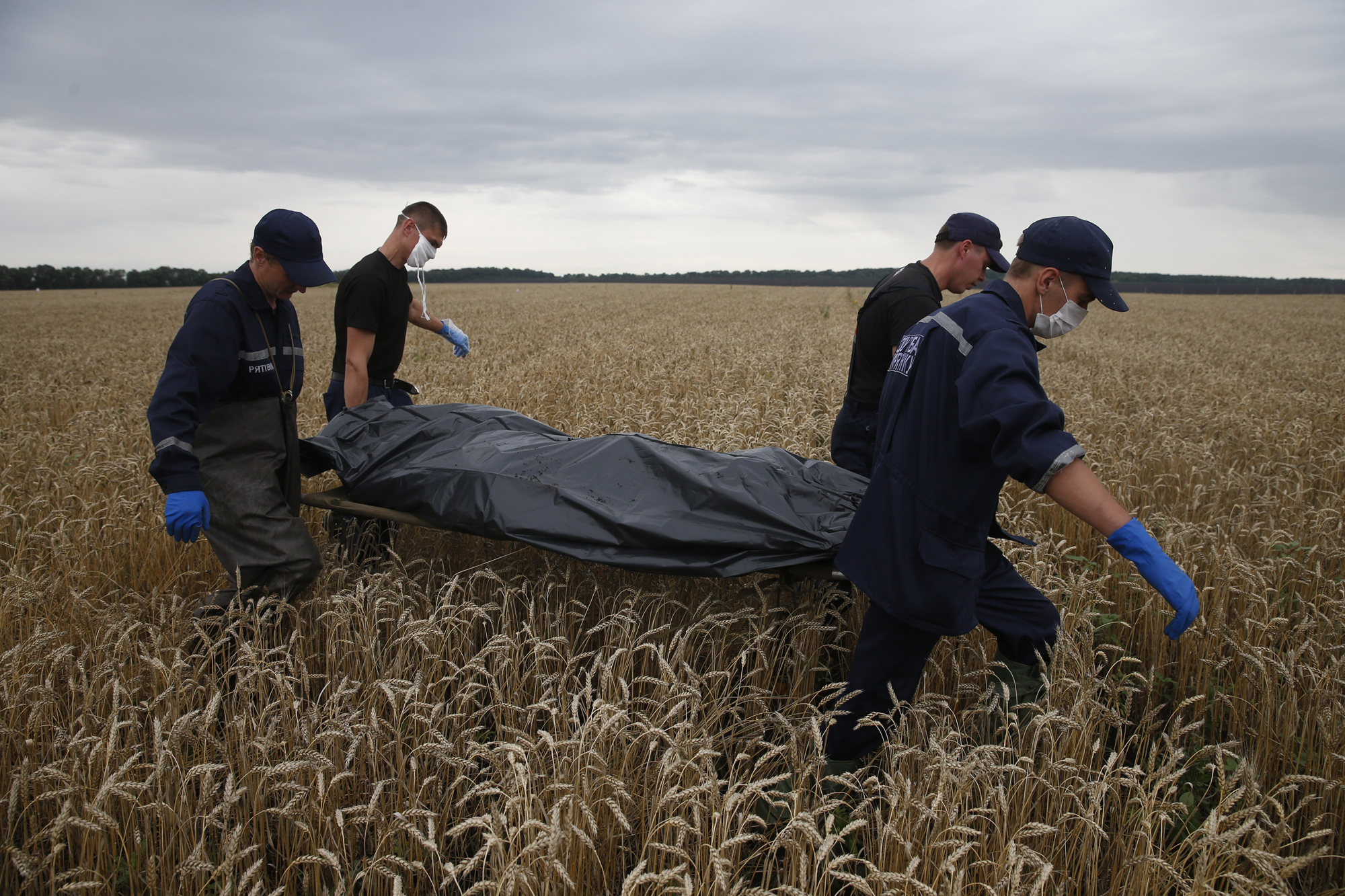 Emergency workers carry a body at the crash site of Malaysia Airlines Flight MH17, near the settlement of Grabovo in the Donetsk region, July 19, 2014. (Maxim Zmeyev—Reuters)