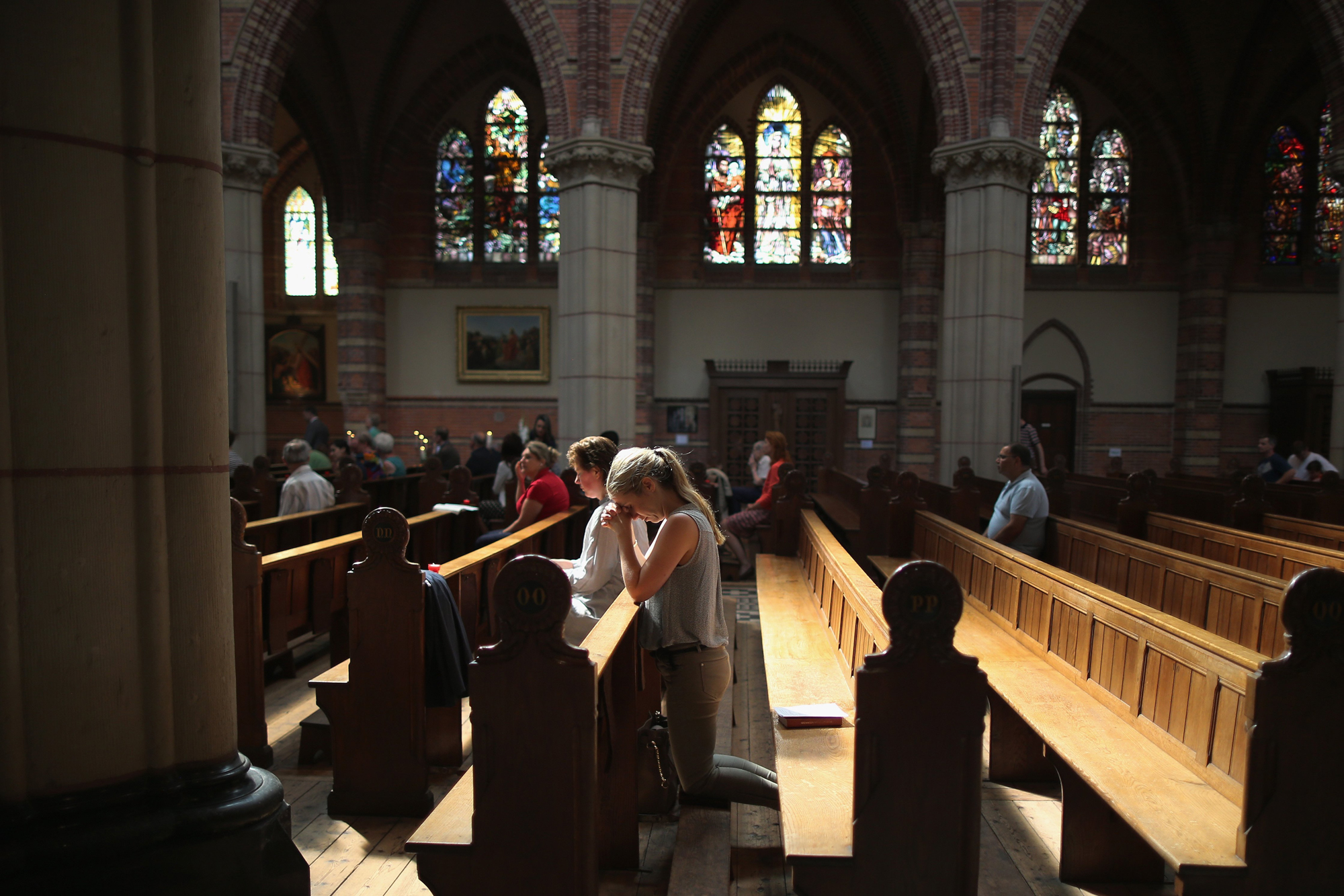 Local people pray during a special mass in Saint Vitus Church in memory of the victims of Malaysia Airlines flight MH17 on July 20, 2014 in Hilversum, Netherlands.