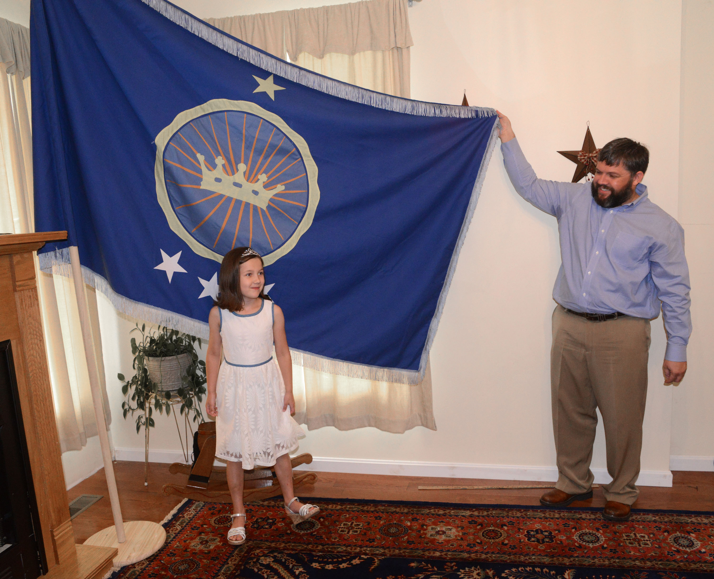 Jeremiah Heaton and his seven year-old daughter, Princess Emily, show the flag on July 2, 2014, in Abingdon, Virginia, that their family designed as they try to claim a piece of land in the Eastern African region of Bir Tawil. (David Crigger—AP)