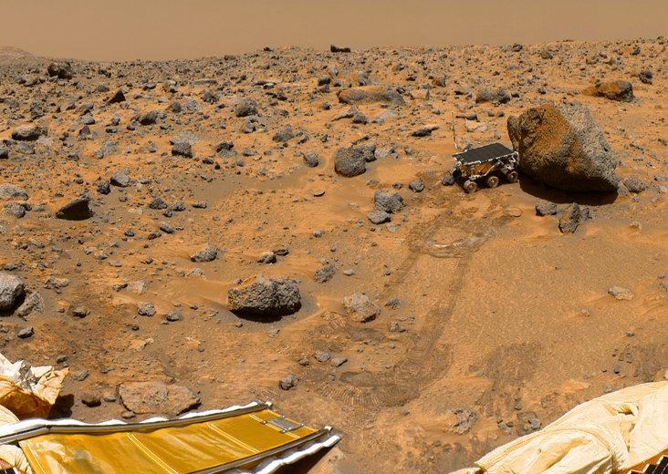 NASA’s Sojourner robotic rover examining a boulder on Mars’s Chryse Planitia, as imaged by its parent spacecraft, Pathfinder, after landing on the planet on July 4, 1997. Parts of Pathfinder’s solar arrays and the rover’s down ramp are in the foreground.