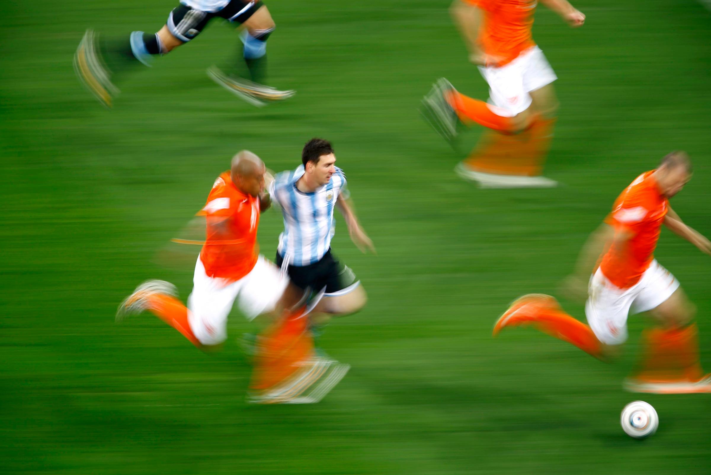 Argentina's Lionel Messi fights for the ball with Nigel de Jong of the Netherlands during their 2014 World Cup semi-finals at the Corinthians arena