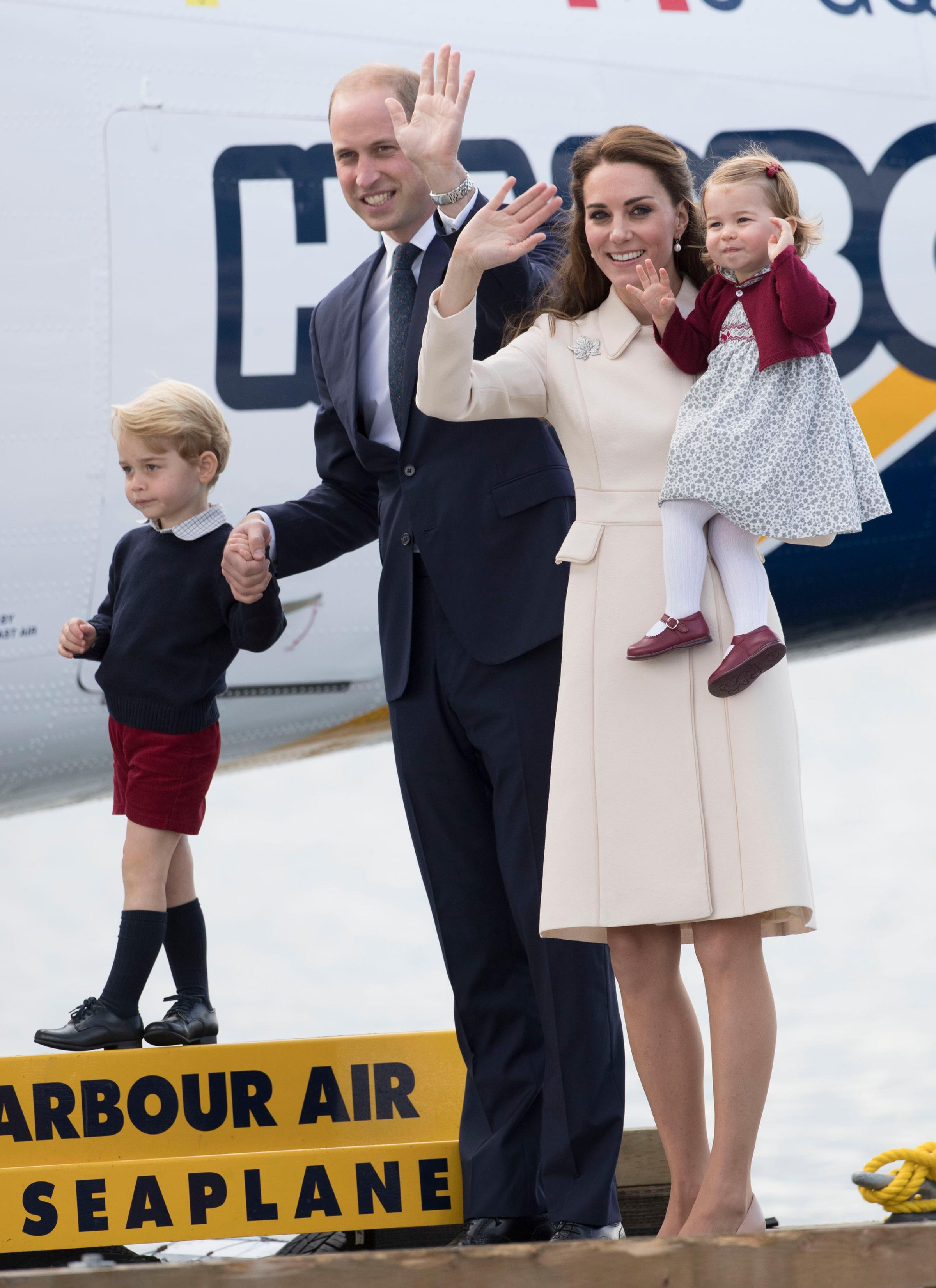 Prince William, Duke of Cambridge, Prince George of Cambridge, Catherine, Duchess of Cambridge and Princess Charlotte wave as they leave from Victoria Harbour to board a sea-plane on the final day of their Royal Tour of Canada on Oct. 1, 2016.