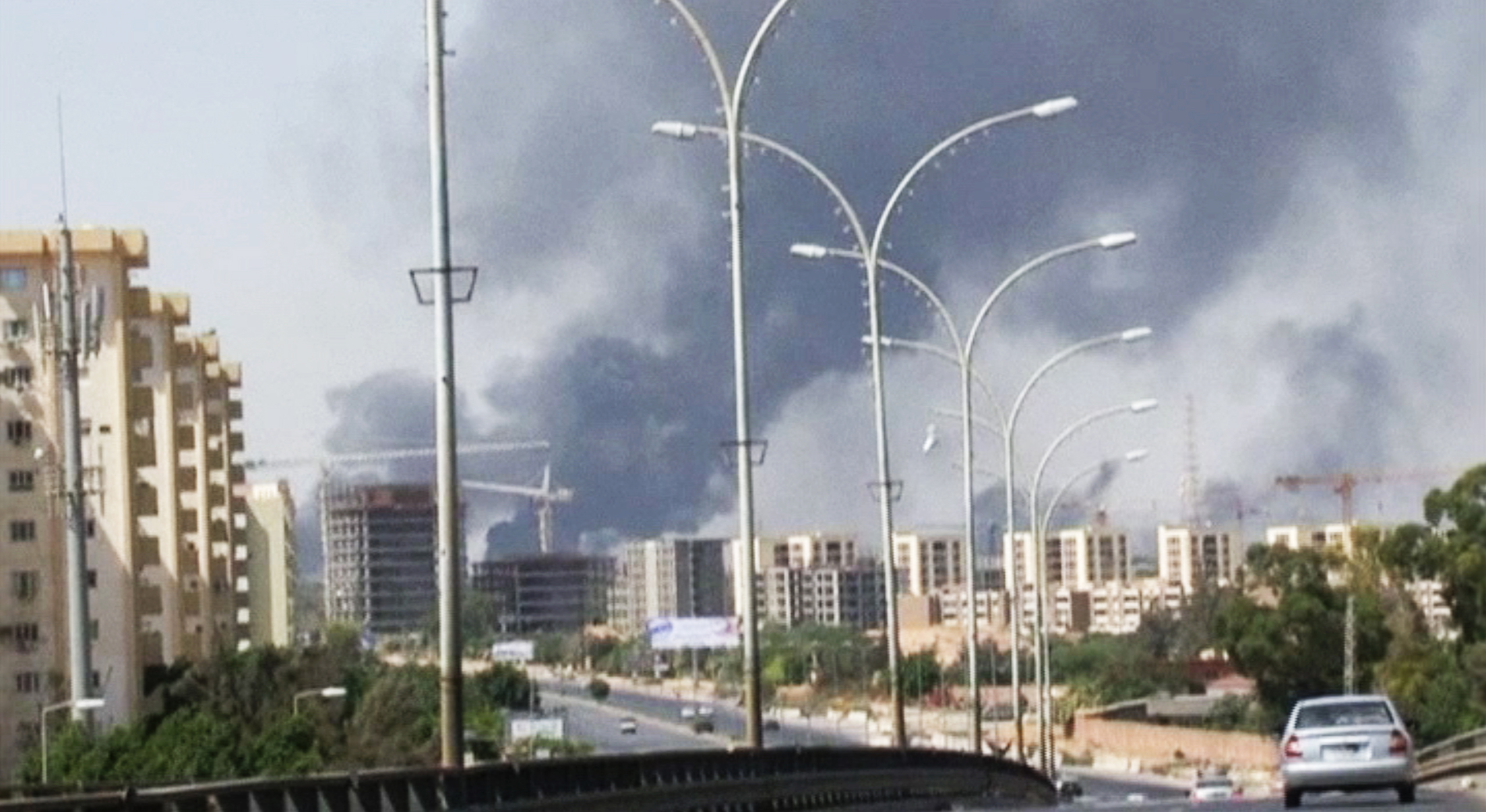 In this image made from video by the Associated Press, smoke rises from the direction of Tripoli International Airport, in the capital of Libya, on July 13, 2014 (AP)