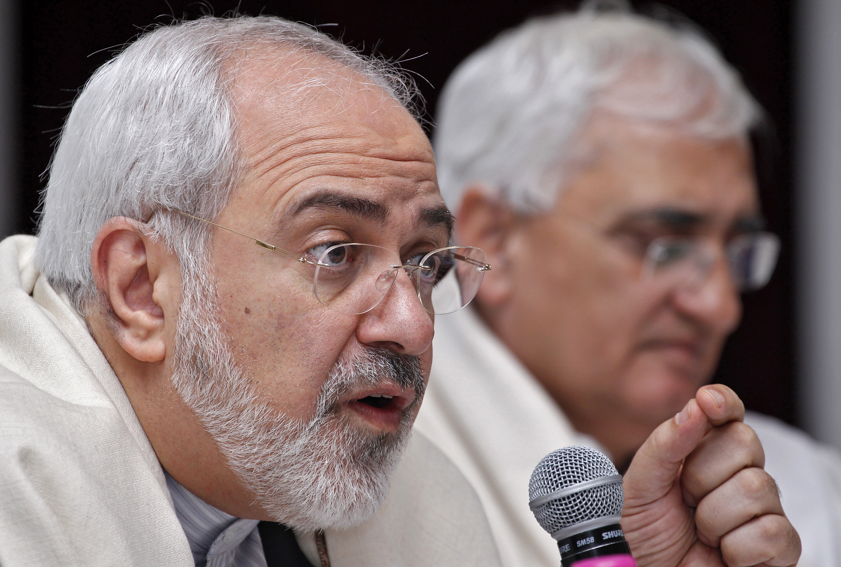 Iran's Foreign Minister Mohammad Javad Zarif speaks as his Indian counterpart Salman Khurshid watches during a lecture themed "Iran's Foreign Policy - Towards Stability in West Asia" organized by the Observer Research Foundation in New Delhi on February 27, 2014. 