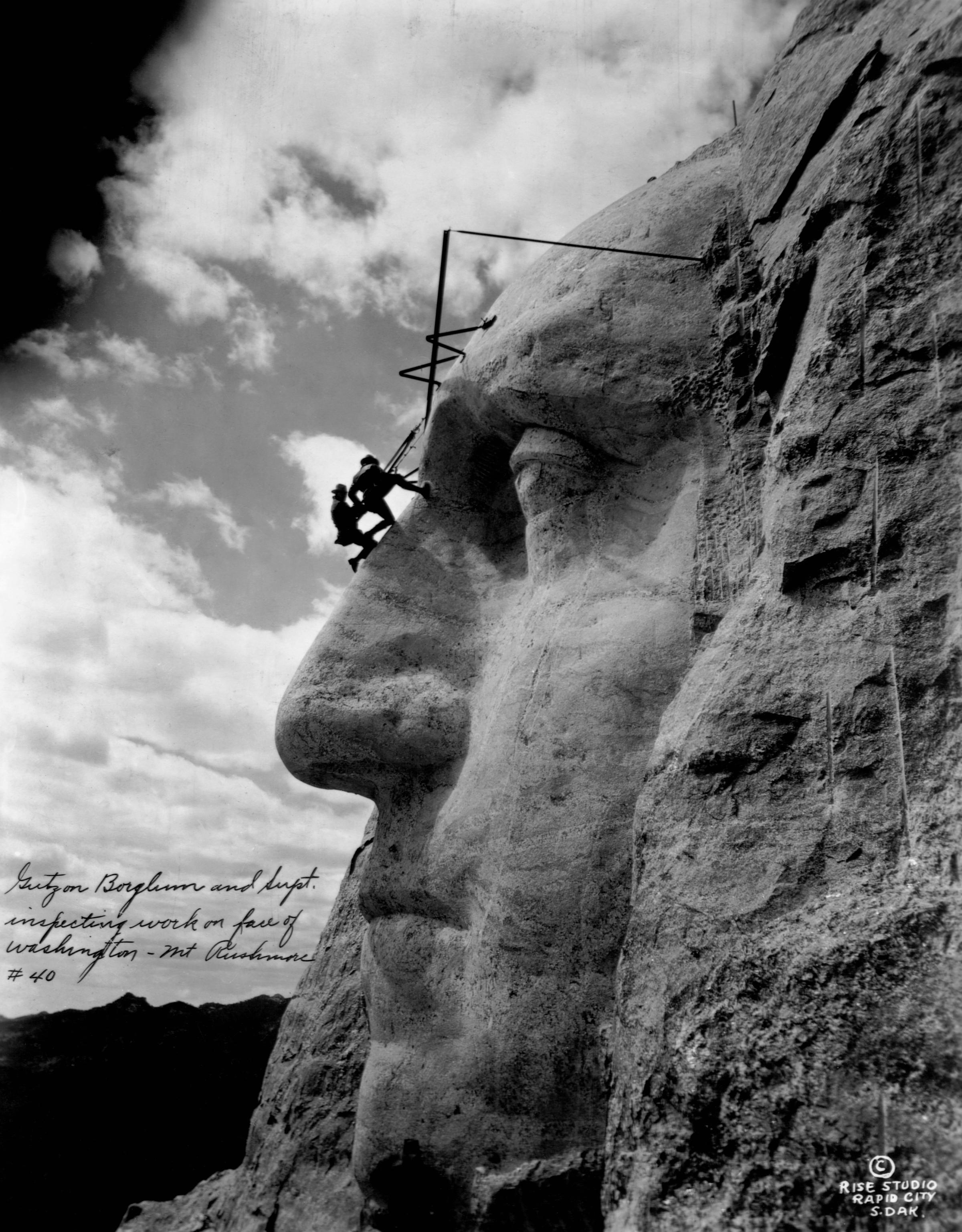 Gutzon Borglum Inspecting Washington's Statue on Mount Rushmore