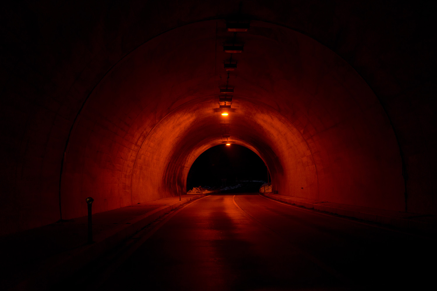 Japan, Namie, 2014. A tunnel is lit by red lights inside the 20-kilometer exclusion zone near the crippled Fukushima Daiichi Nuclear Power Station.