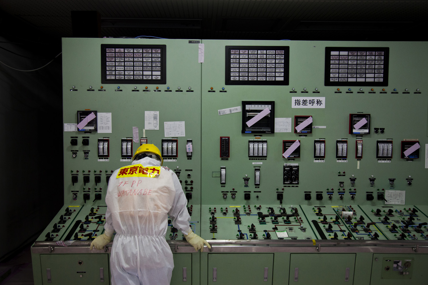 Japan, Okuma, 2014.A TEPCO worker in charge of security inside the Central Control Room for Reactor 1 and 2 which both had a meltdown and exploded after the earthquake and tsunami hit the east coast of japan in 2011.