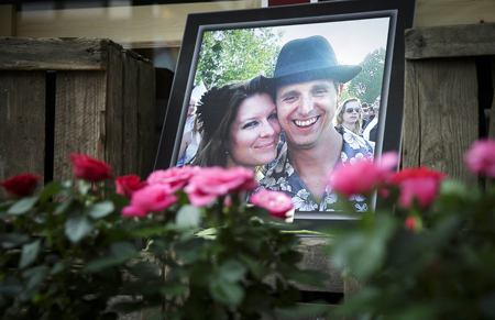 A portrait of Neeltje Tol and Cor Schilder is placed with flowers and candles in front of their flower shop in Volendam, Netherlands,July 19, 2014. (Phil Nijhuis—AP)