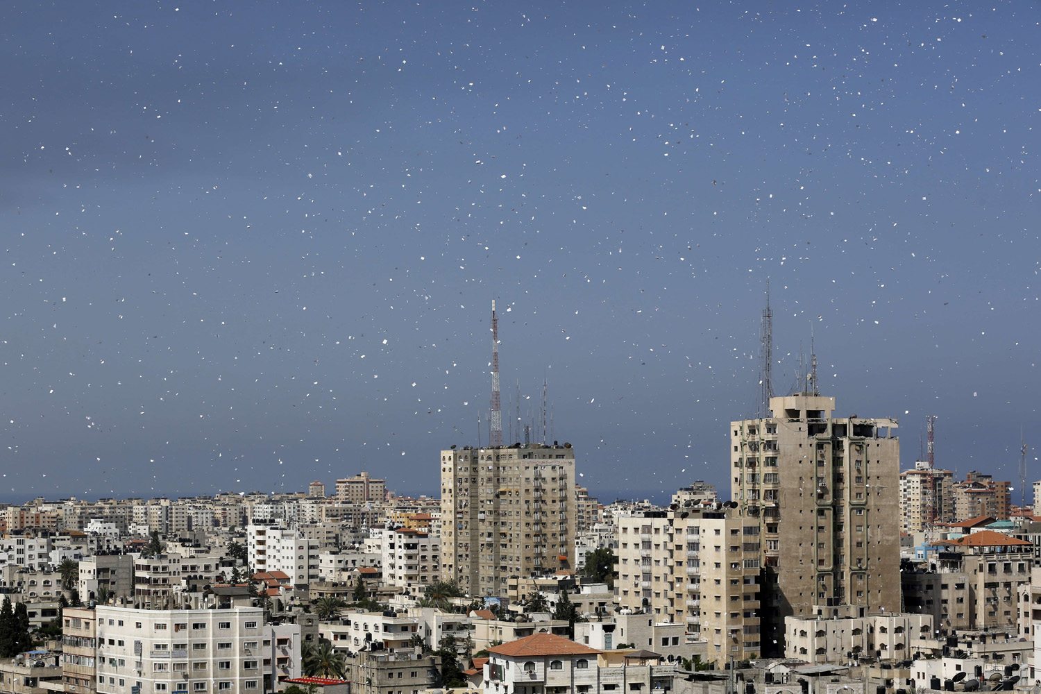 Flyers are dropped over Gaza City by the Israeli army urging residents to evacuate their homes on July 30, 2014.
