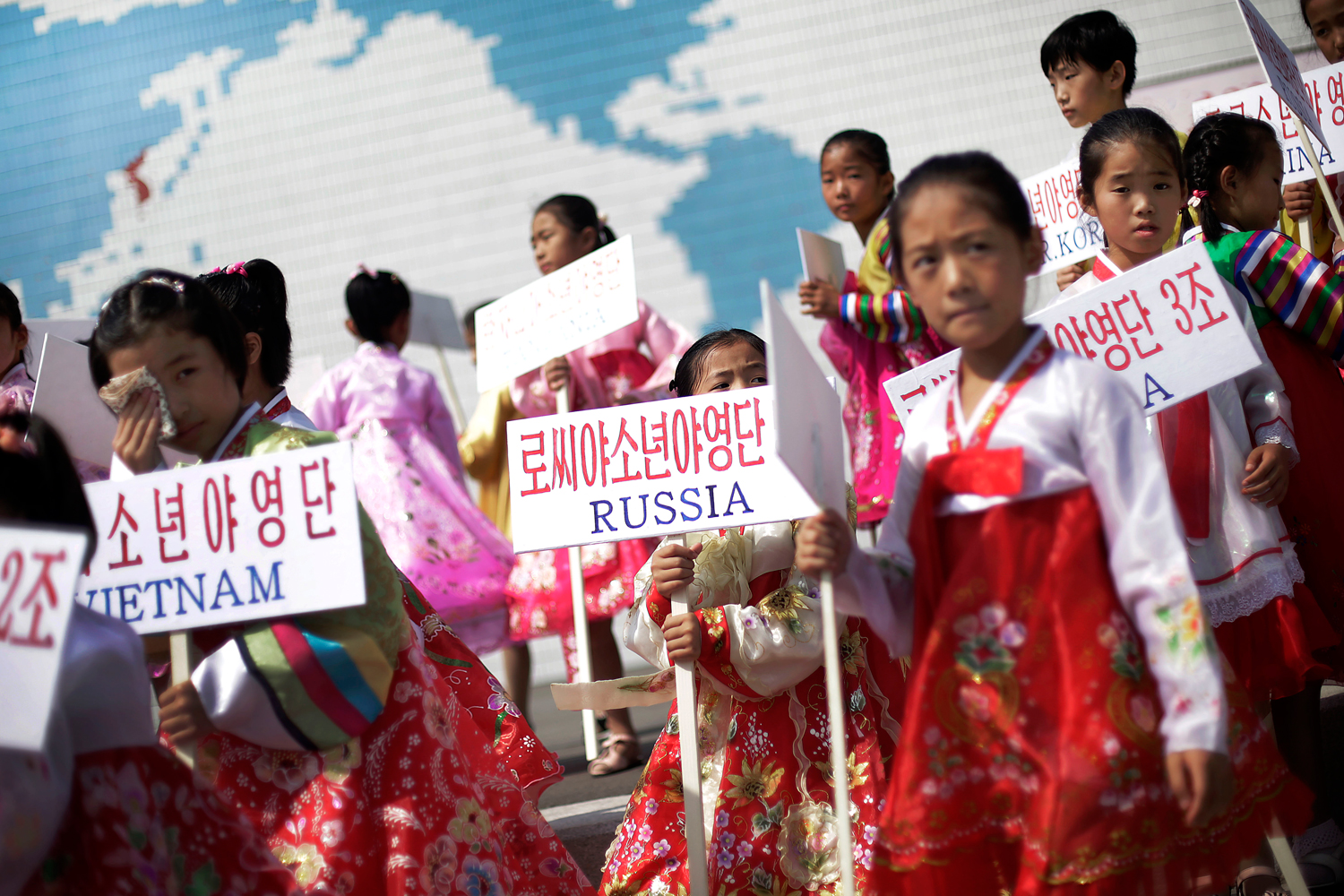 Young North Korean girls hold up signboards with the names of participating countries during an opening ceremony at the Songdowon International Children's Camp, Tuesday, July 29, 2014, in Wonsan, North Korea. (Wong Maye-E –AP)