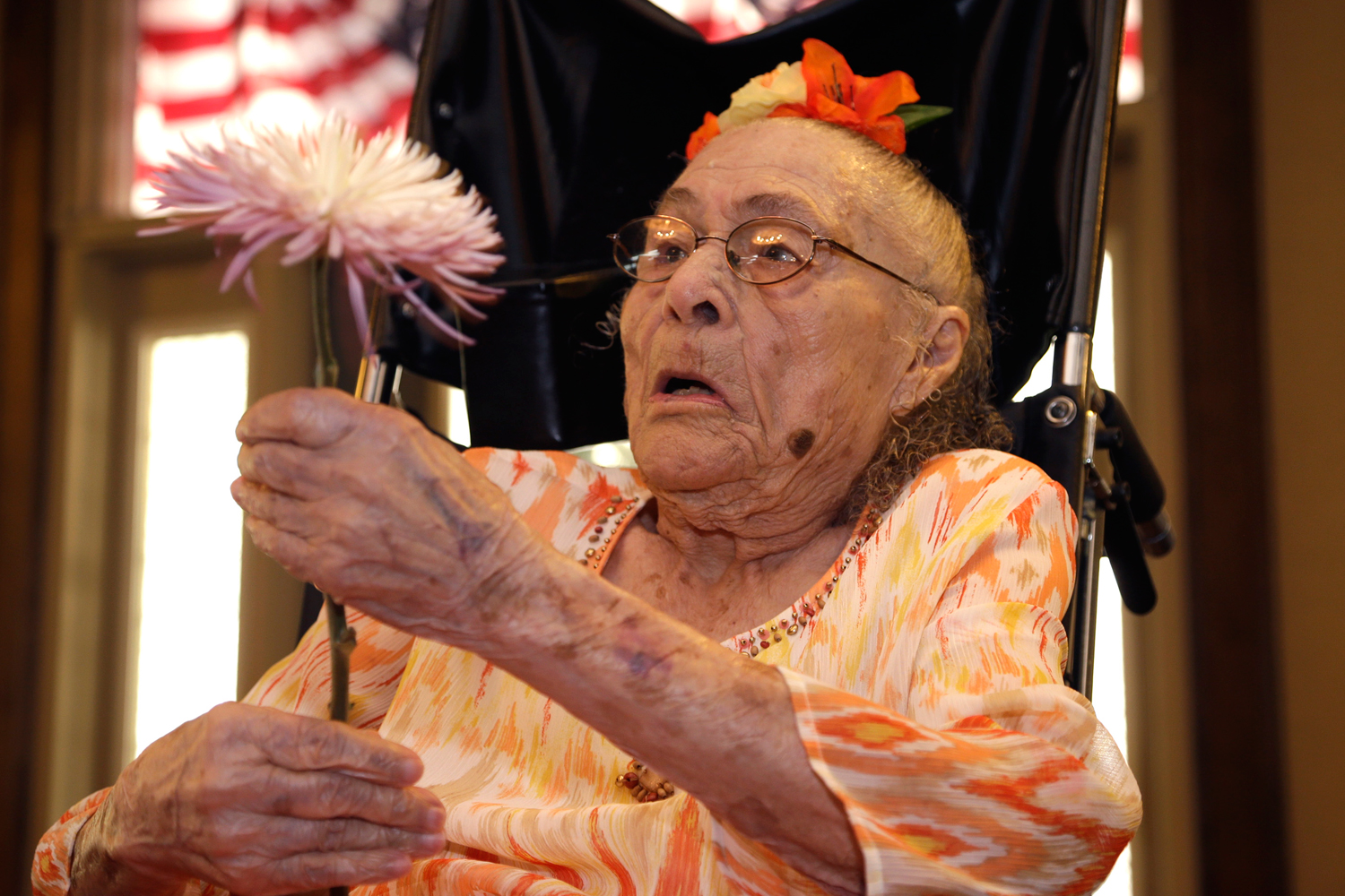 Gertrude Weaver holds a flower given to her a day before her 116th birthday at Silver Oaks Health and Rehabilitation in Camden, Ark on July 3, 2014. (Danny Johnston / AP)