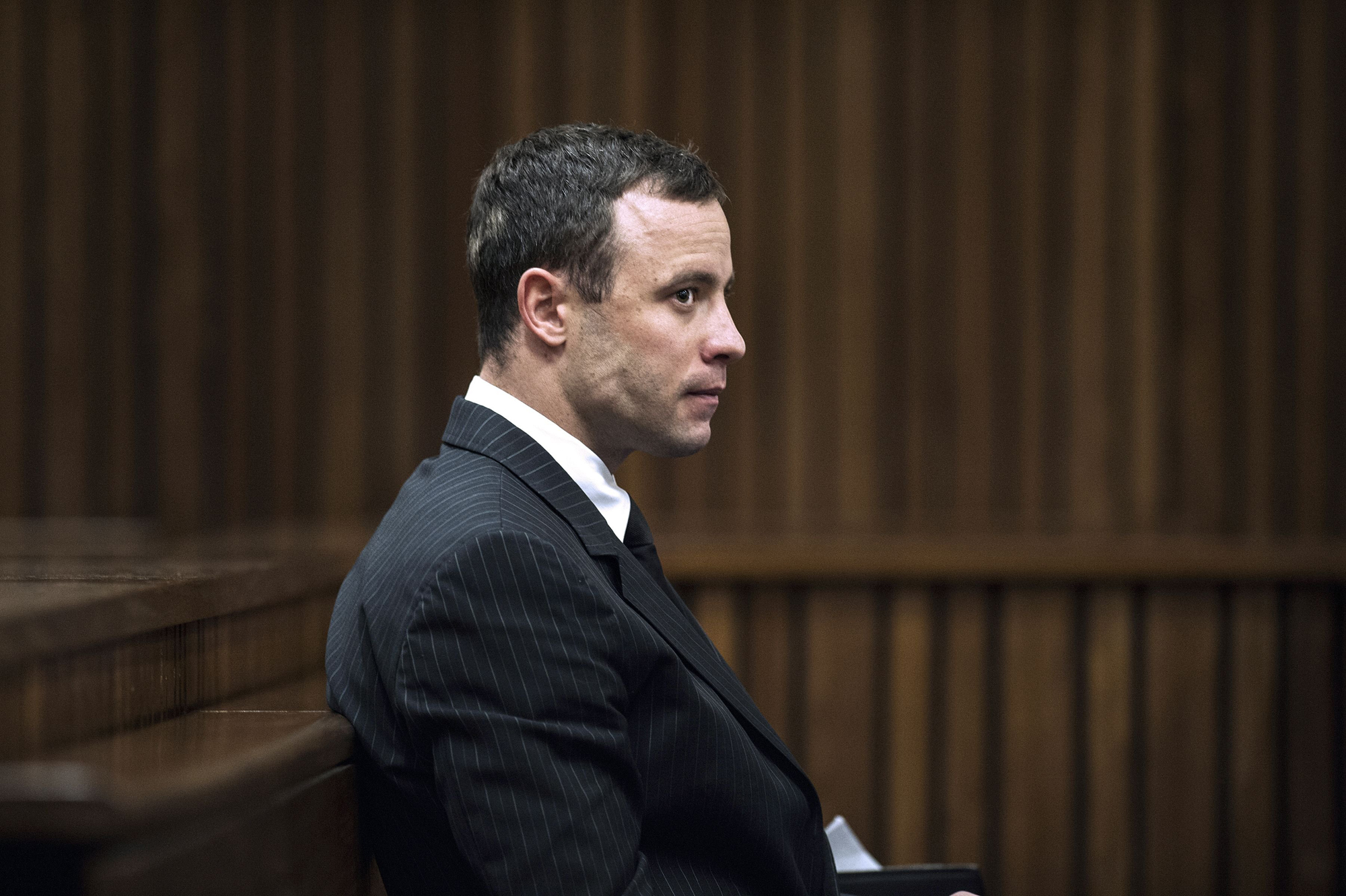 Paralympian Oscar Pistorius sits in the dock during his murder trial at the High Court in Pretoria, on July 2, 2014. (Gianluigi Guercia—AFP/Getty Images)