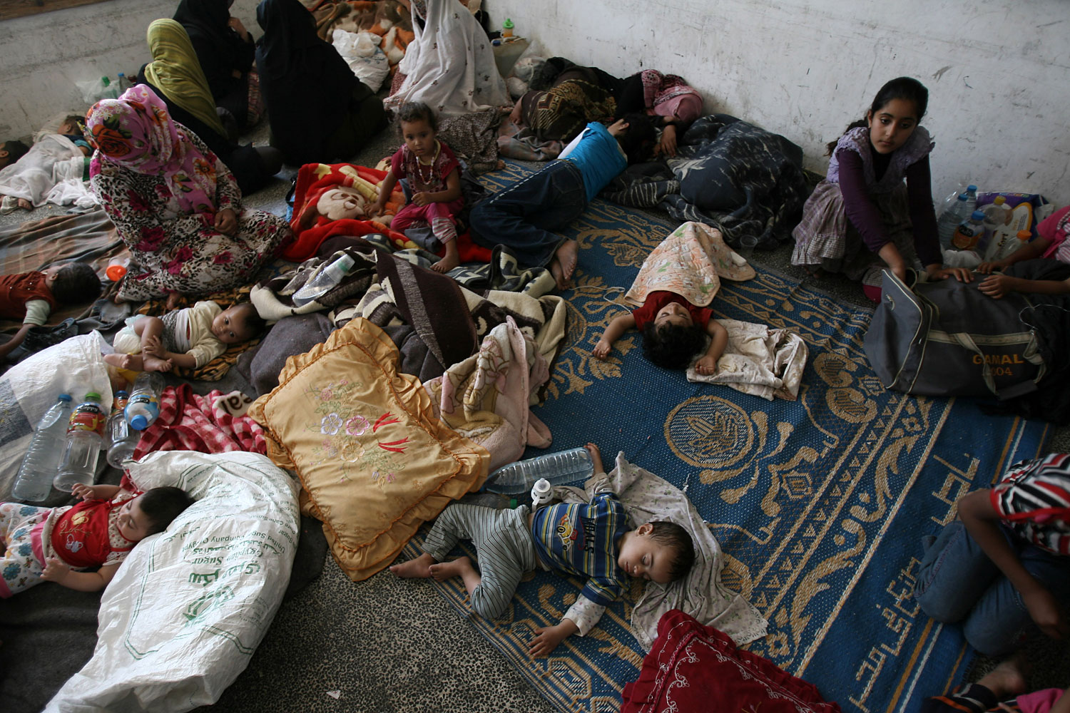 Palestinians, who fled their houses following an Israeli ground offensive, at a UN school in Rafah in the southern Gaza Strip, July 19, 2014.