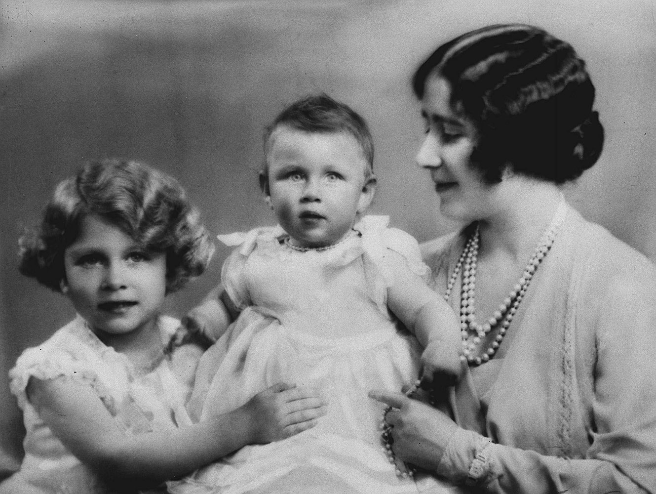The naughty sister: the baby Princess Margaret, flanked by Princess Elizabeth and their mother, led a colorful life. Prevented from marrying her first love, a divorced commoner, she later married, and divorced, fashionable photographer Antony Armstrong-Jones.