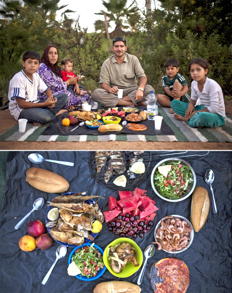 A Syrian refugee family waits to break their fast next to the Temporary Centre for Immigrants in the Spanish enclave of Melilla, Spain on July 8, 2014.