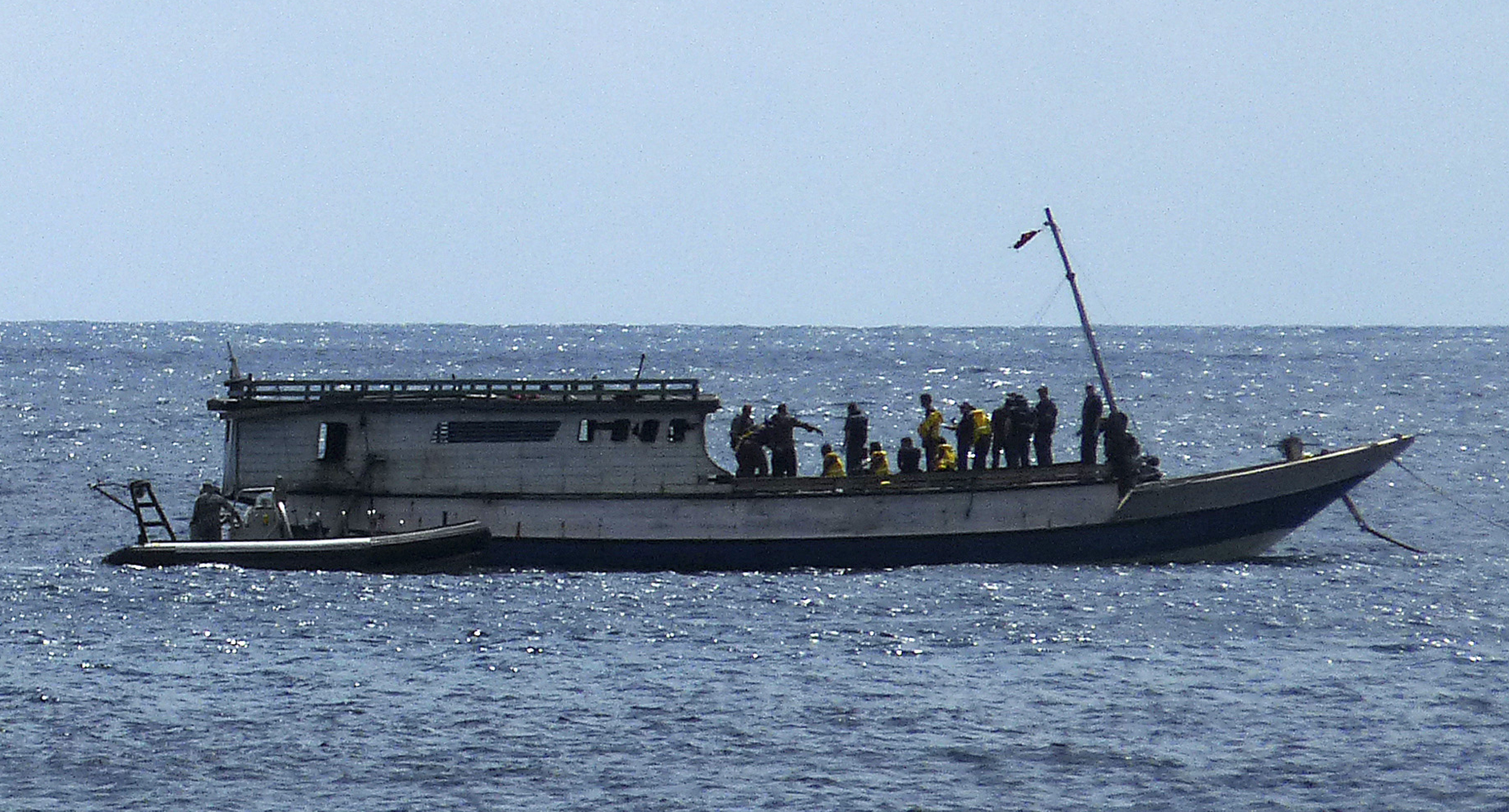 Australian Navy boat comes alongside a boat carrying 50 asylum seekers after it arrived at Flying Fish Cove on Christmas Island