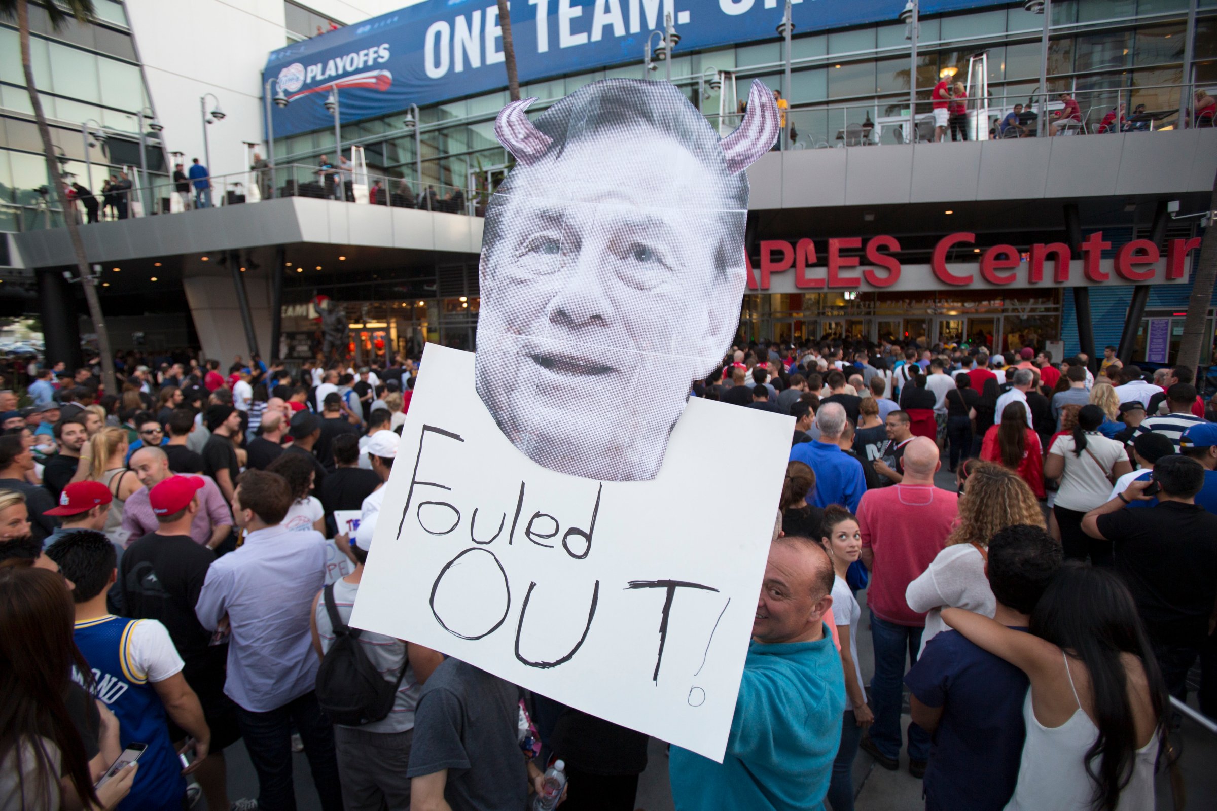 A supporter holds a photo cutout of Los Angeles Clippers owner Donald Sterling while standing in line for the NBA Playoff game 5 between Golden State Warriors and Los Angeles Clippers at Staples Center in Los Angeles